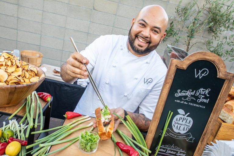 A chef smiles at the camera