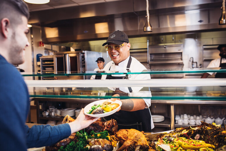 Cheerful Wolfgang Puck Catering staff Member